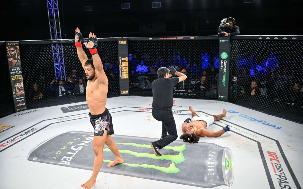 Erick Visconde celebrates a victory inside the LFA cage