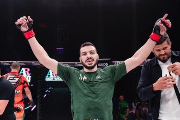 Ilias Bulaid celebrates an MMA victory inside the cage