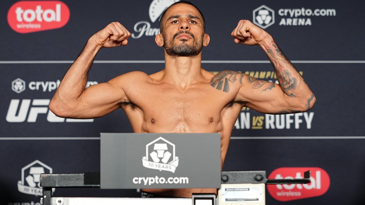 Alexandre Pantoja on the scale at the UFC 331 official weigh-in